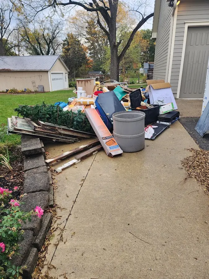 Dumpster being loaded with debris for Roofing Dumpster Rental in Silver City